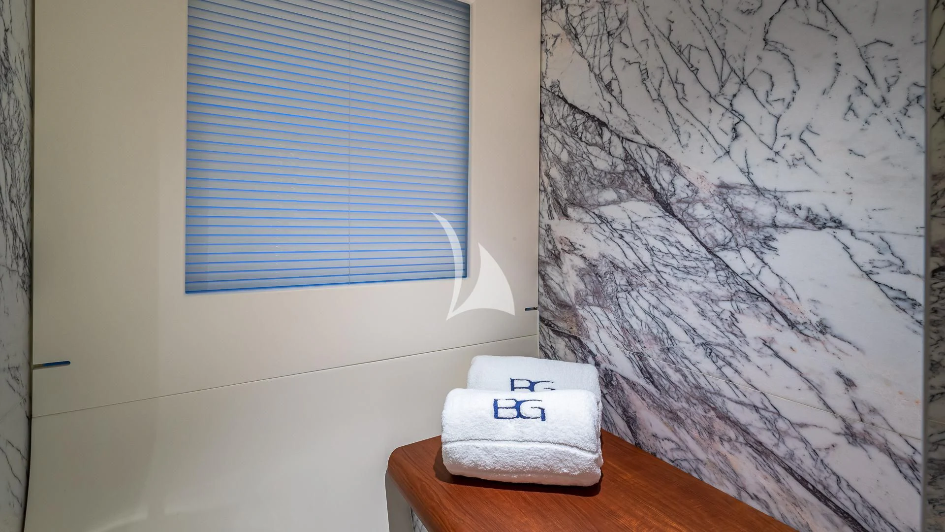 a white toilet paper on a wooden table next to a window aboard VOLO MARE Yacht for Charter