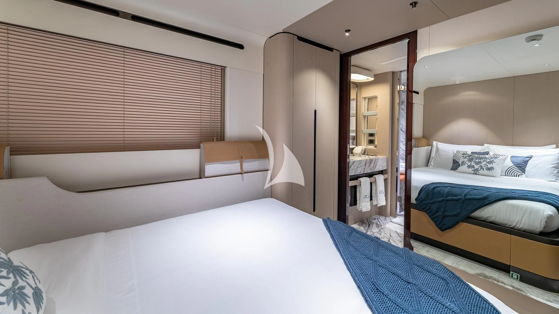 a room with beds and a mirror aboard VOLO MARE Yacht for Charter
