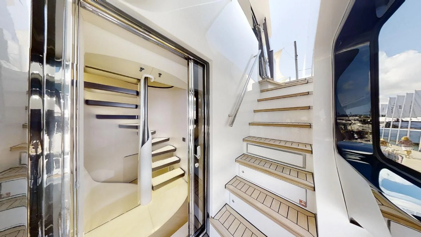 a white staircase in a building aboard VOLO MARE Yacht for Charter