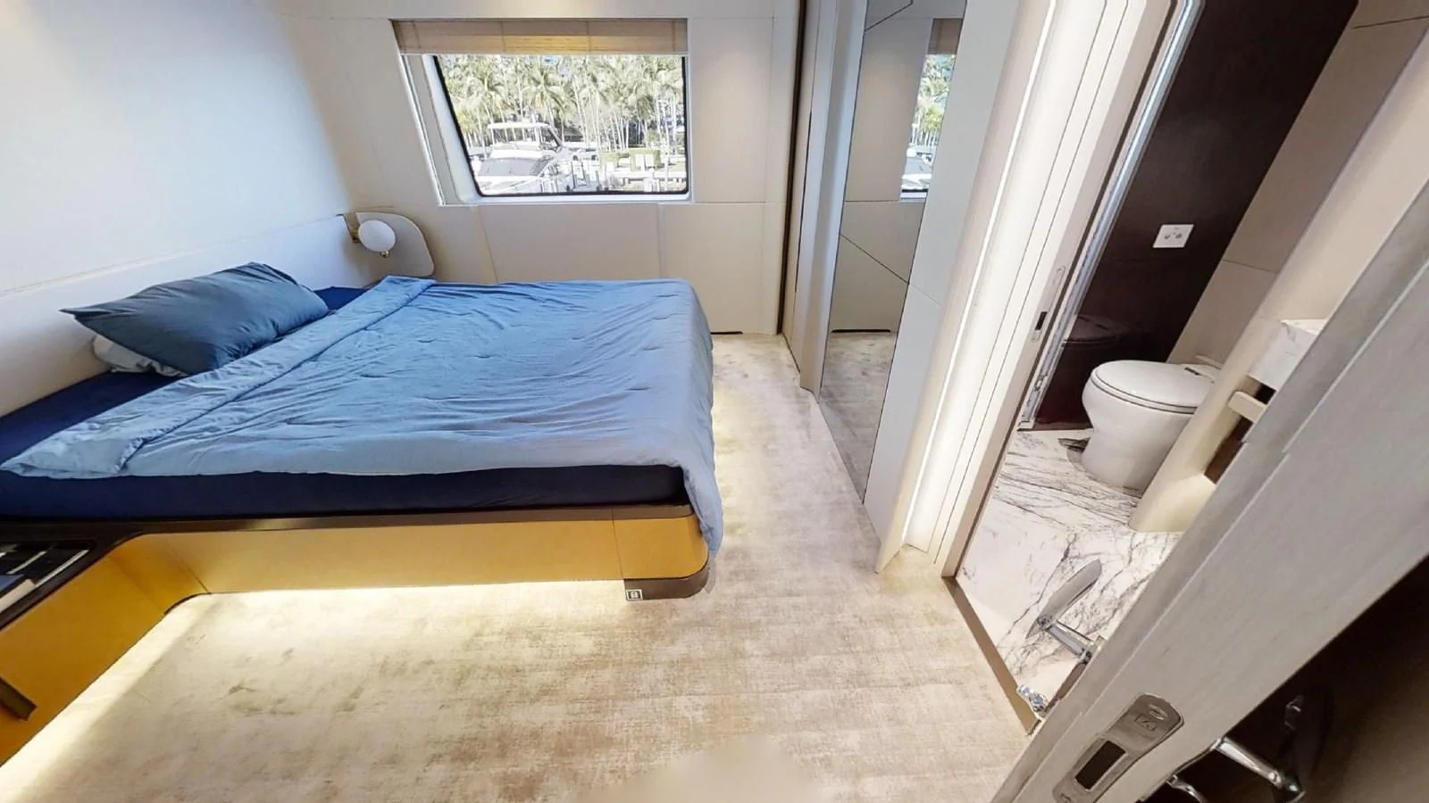 a bedroom with a bed and a window aboard VOLO MARE Yacht for Charter