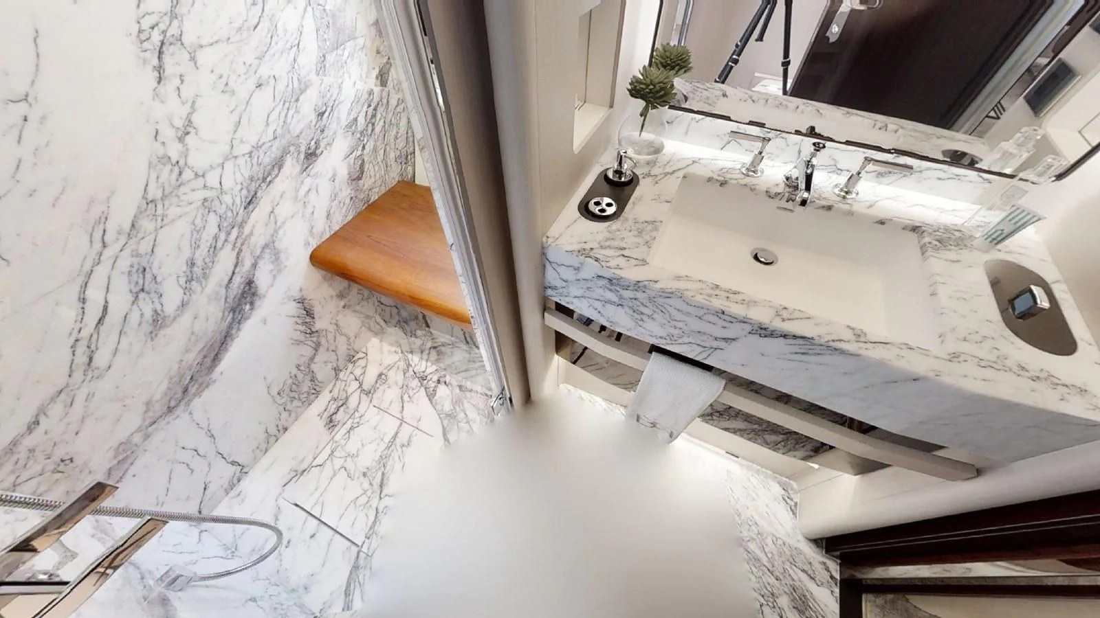 a white bathtub with a wooden seat and a wooden seat on a snowy day aboard VOLO MARE Yacht for Charter
