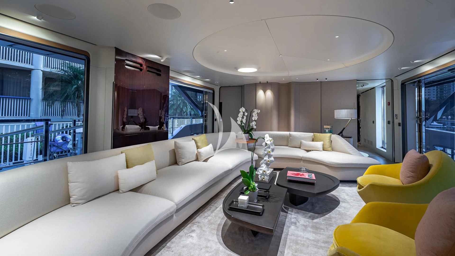a living room with yellow furniture aboard VOLO MARE Yacht for Charter