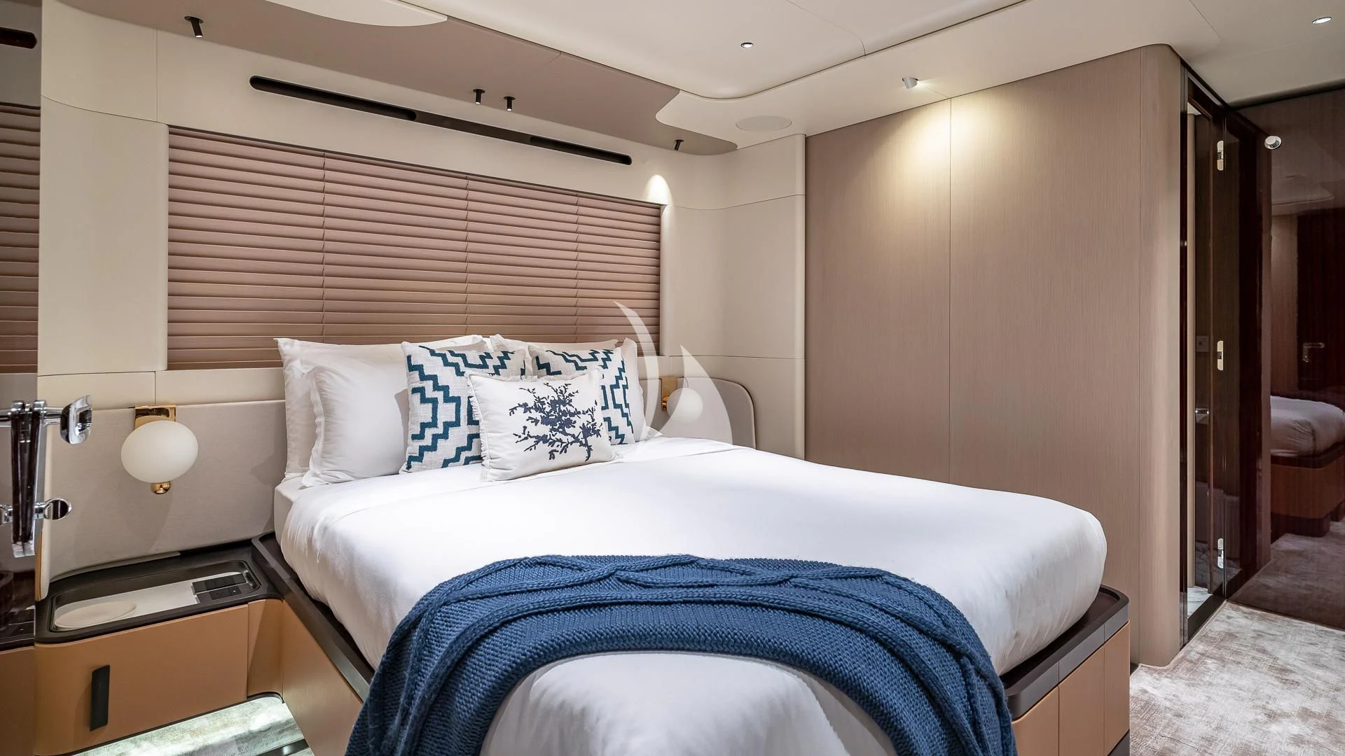 a bed with a blue blanket aboard VOLO MARE Yacht for Charter
