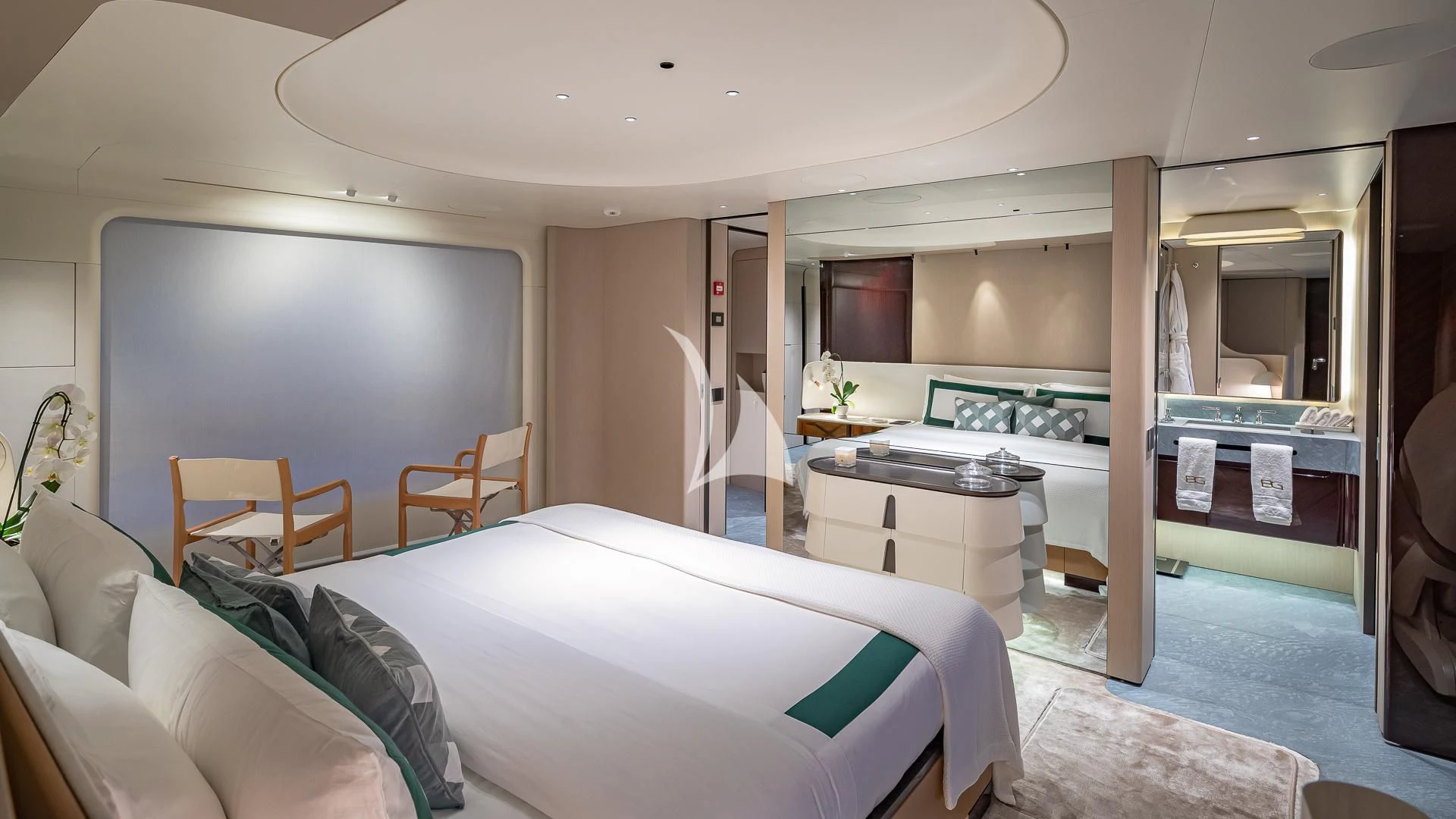 a bedroom with a bed and desk aboard VOLO MARE Yacht for Charter