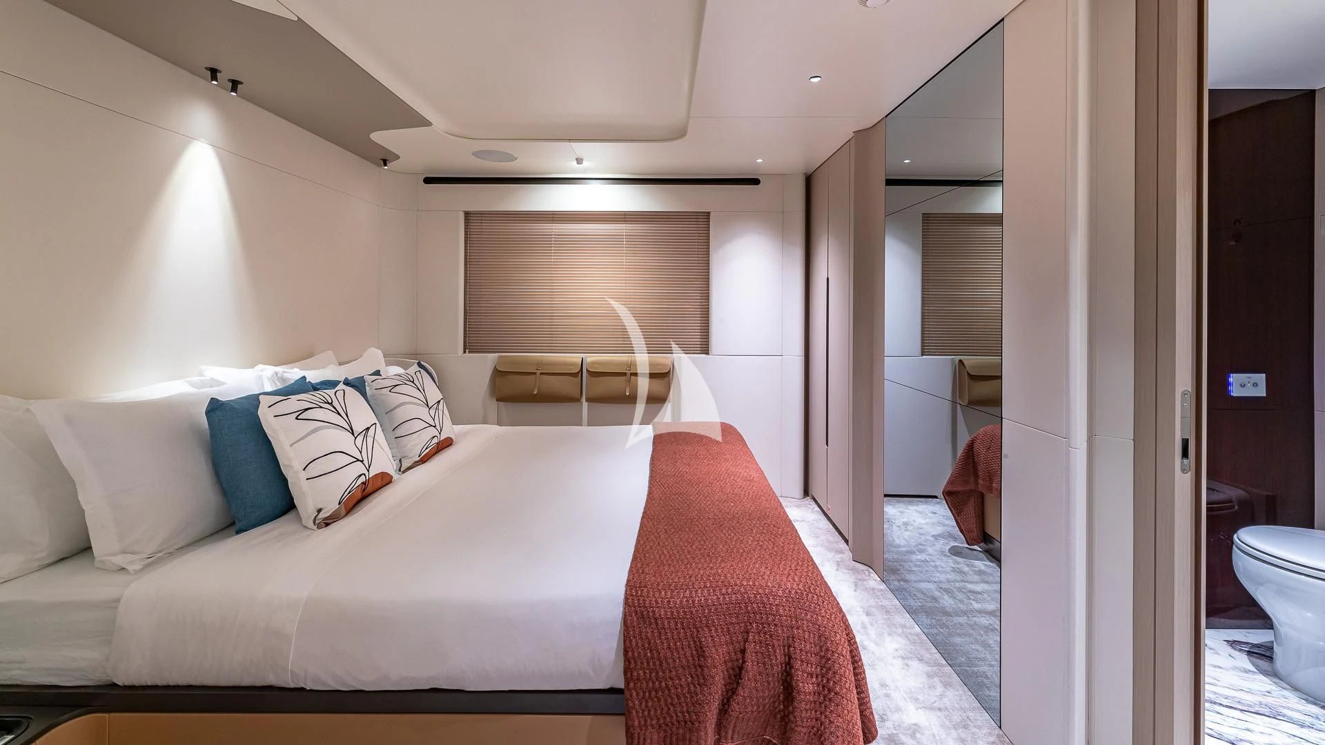 a bedroom with a bed and a mirror aboard VOLO MARE Yacht for Charter
