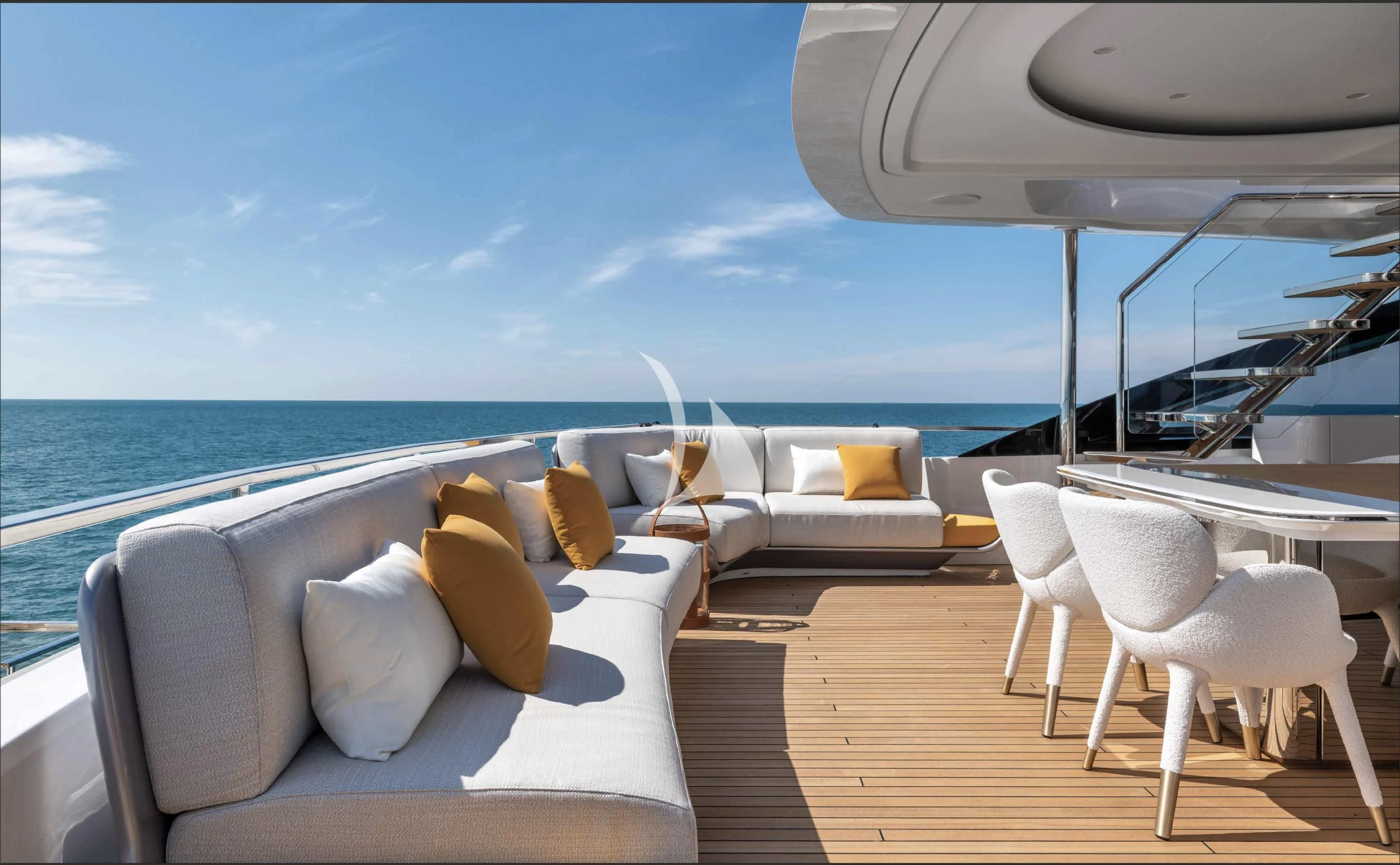 a deck with a large body of water and a large white chair aboard VOLO MARE Yacht for Charter