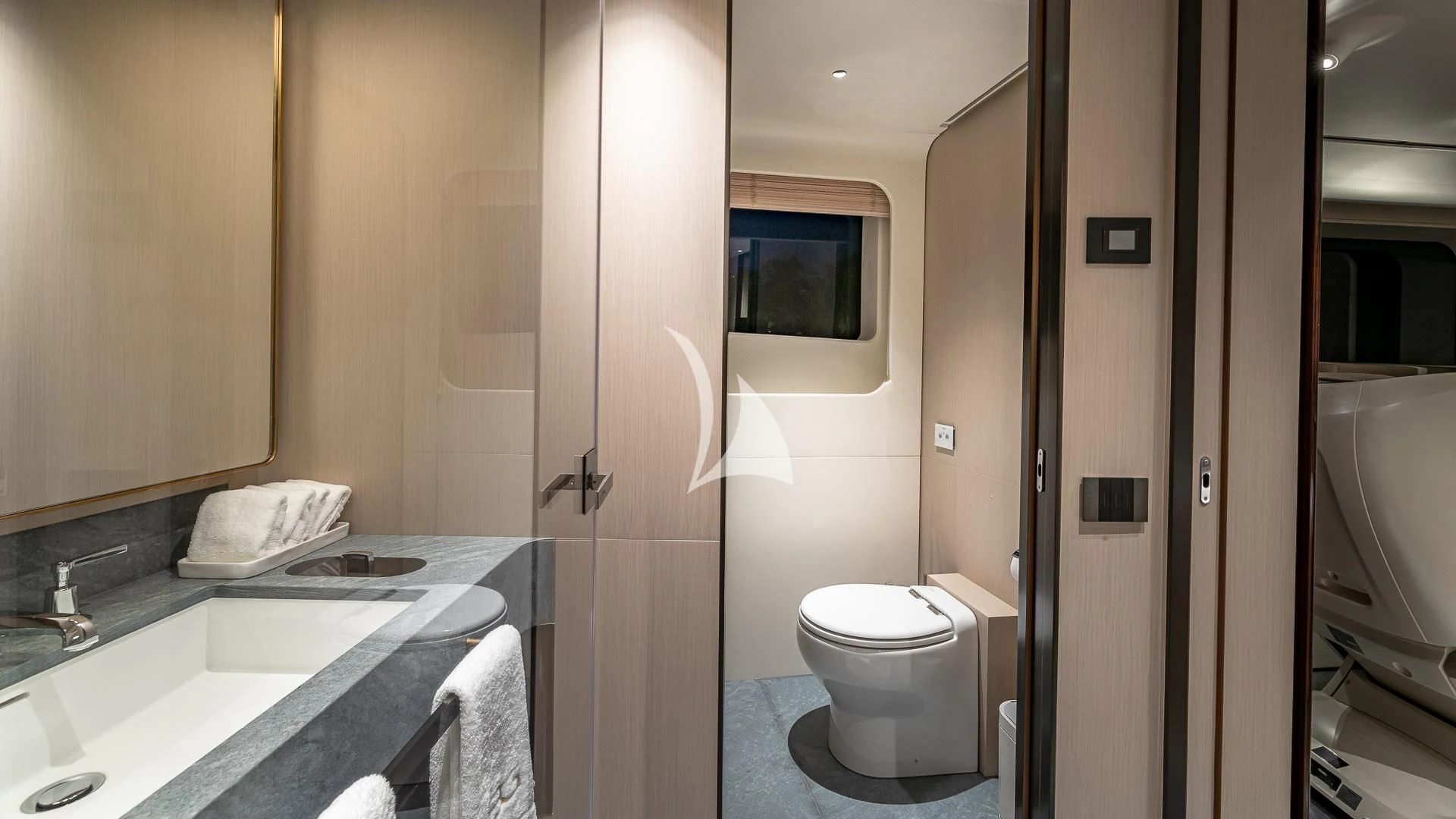 a bathroom with a sink toilet and a mirror aboard VOLO MARE Yacht for Charter