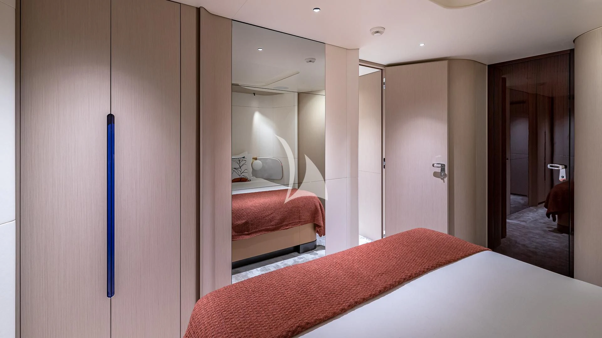 a bedroom with a red bed aboard VOLO MARE Yacht for Charter
