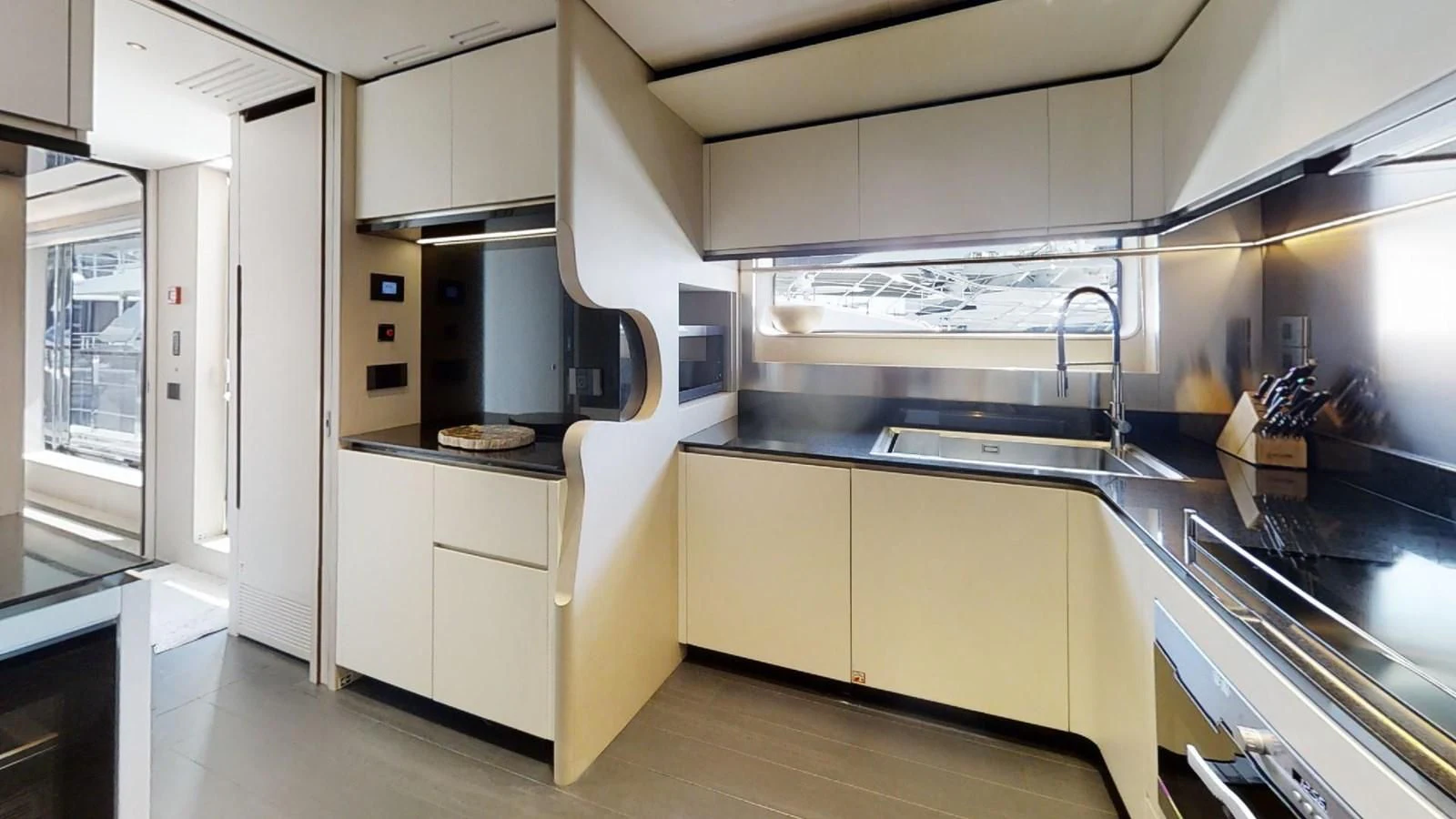 a kitchen with white cabinets aboard VOLO MARE Yacht for Charter