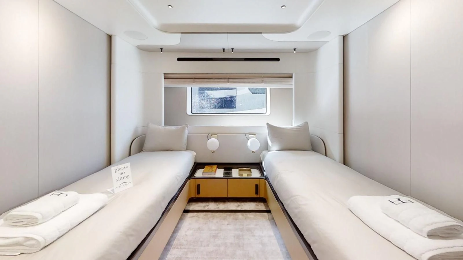 a room with beds and a window aboard VOLO MARE Yacht for Charter