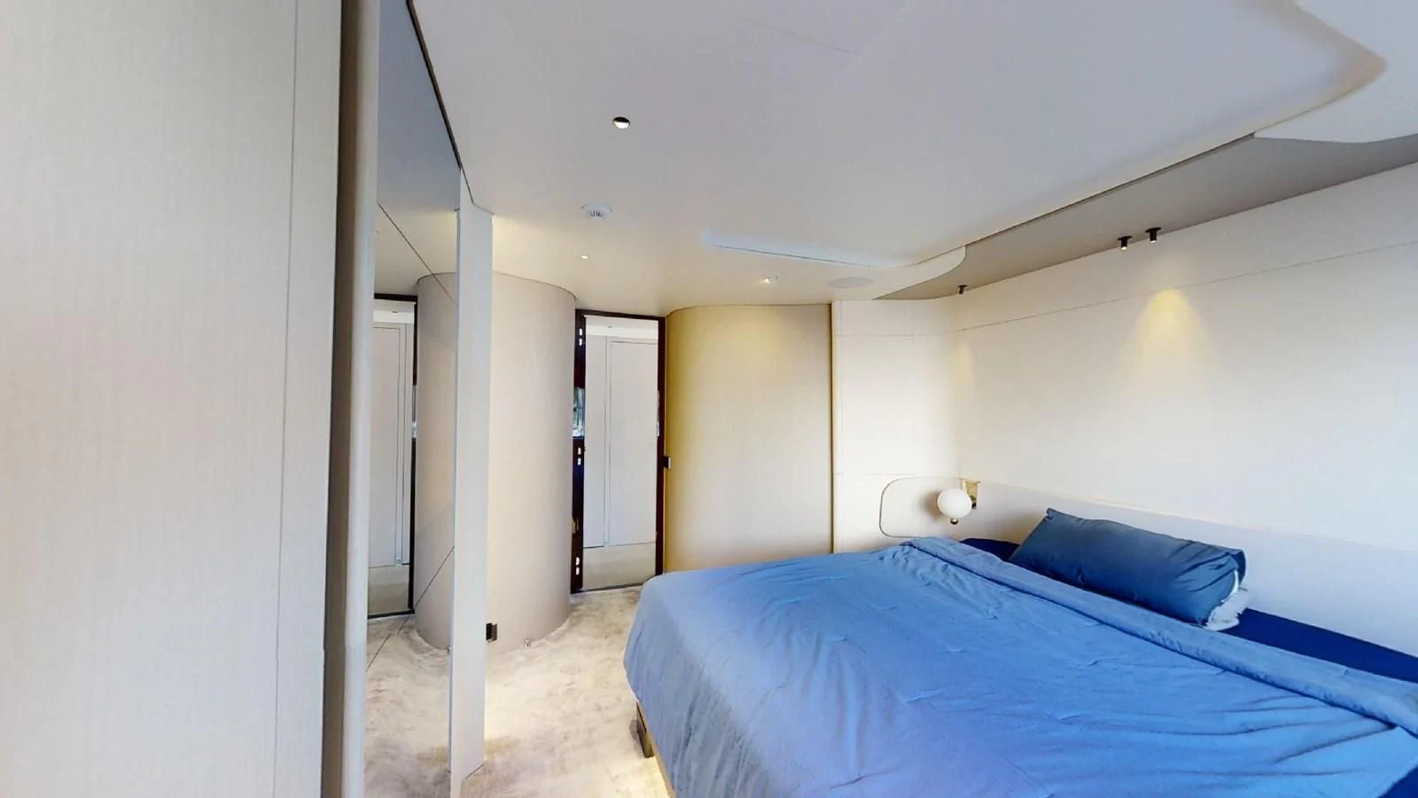 a bedroom with a blue bed aboard VOLO MARE Yacht for Charter