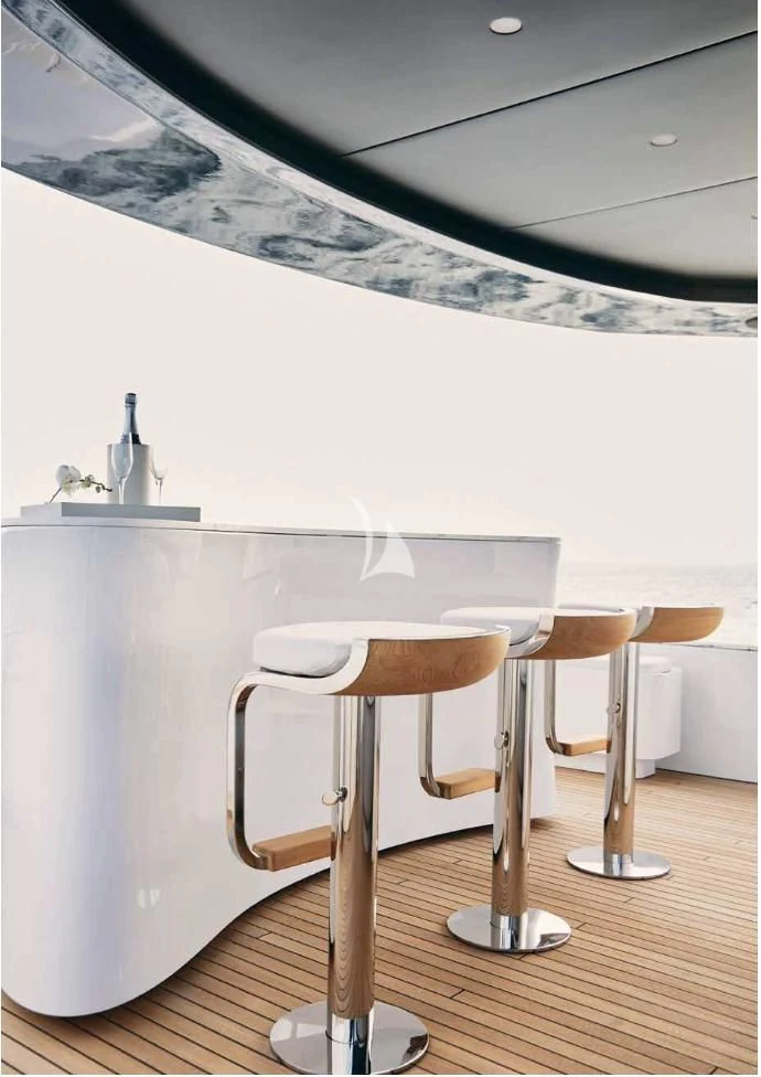 a white table with stools aboard VOLO MARE Yacht for Charter