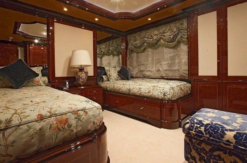 a bedroom with a bed and a dresser aboard AUSTRALIA Yacht for Sale