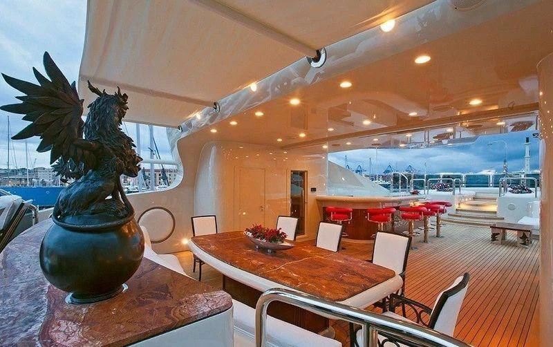 a large room with a table and chairs aboard AUSTRALIA Yacht for Sale