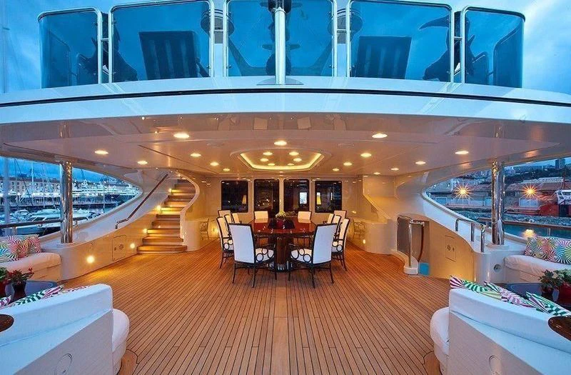 a large room with tables and chairs aboard AUSTRALIA Yacht for Sale