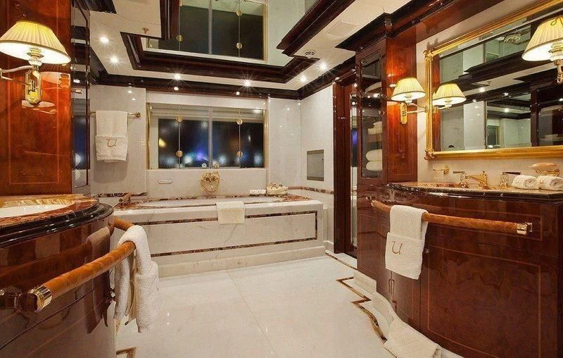 a bathroom with a bathtub and sinks aboard AUSTRALIA Yacht for Sale