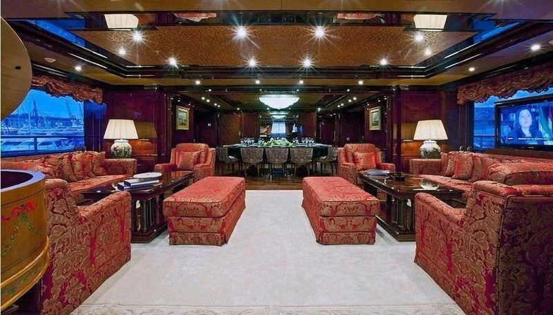 a large room with many chairs and a television aboard AUSTRALIA Yacht for Sale