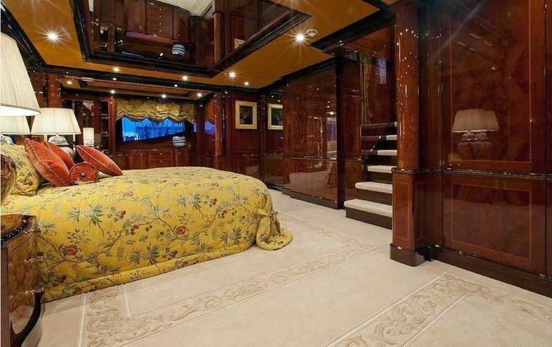 a bedroom with a bed and a staircase aboard AUSTRALIA Yacht for Sale