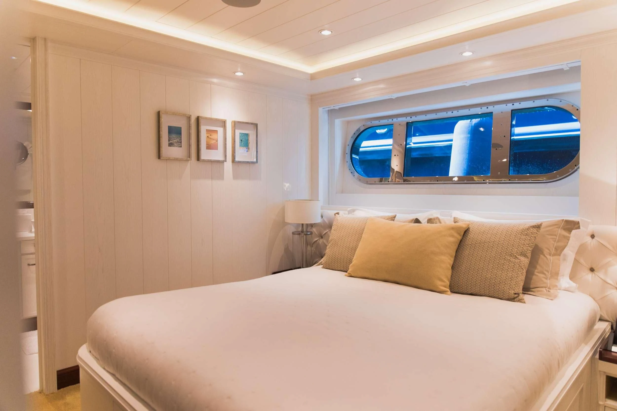 a bed with a white bed spread aboard LADY TRUDY Yacht for Charter