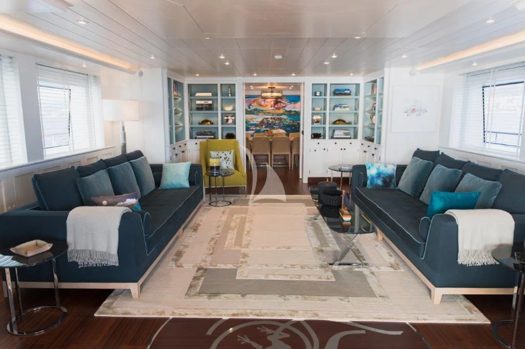 a living room with a blue couch aboard LADY TRUDY Yacht for Charter