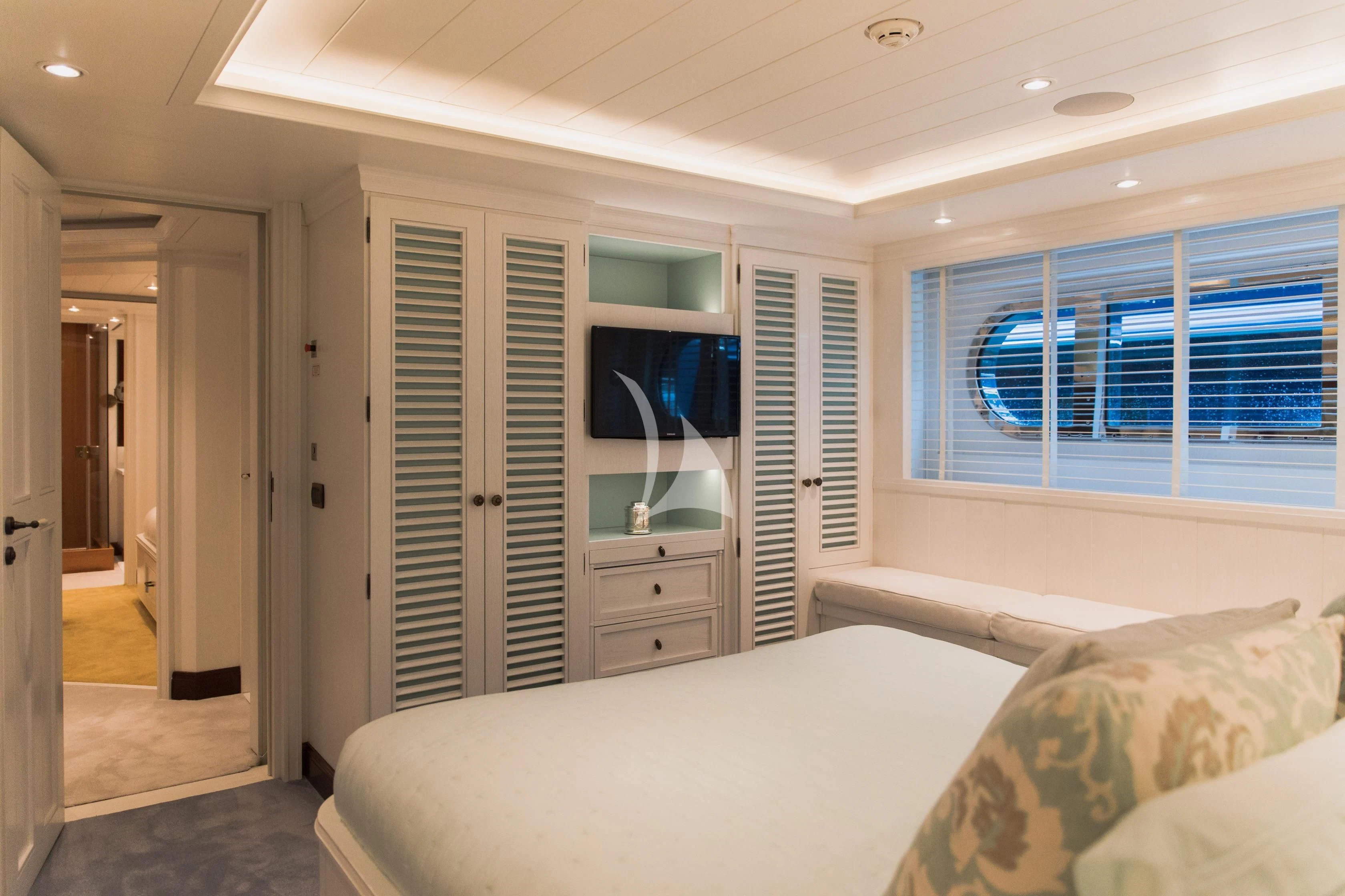 a bedroom with a bed and a television aboard LADY TRUDY Yacht for Charter