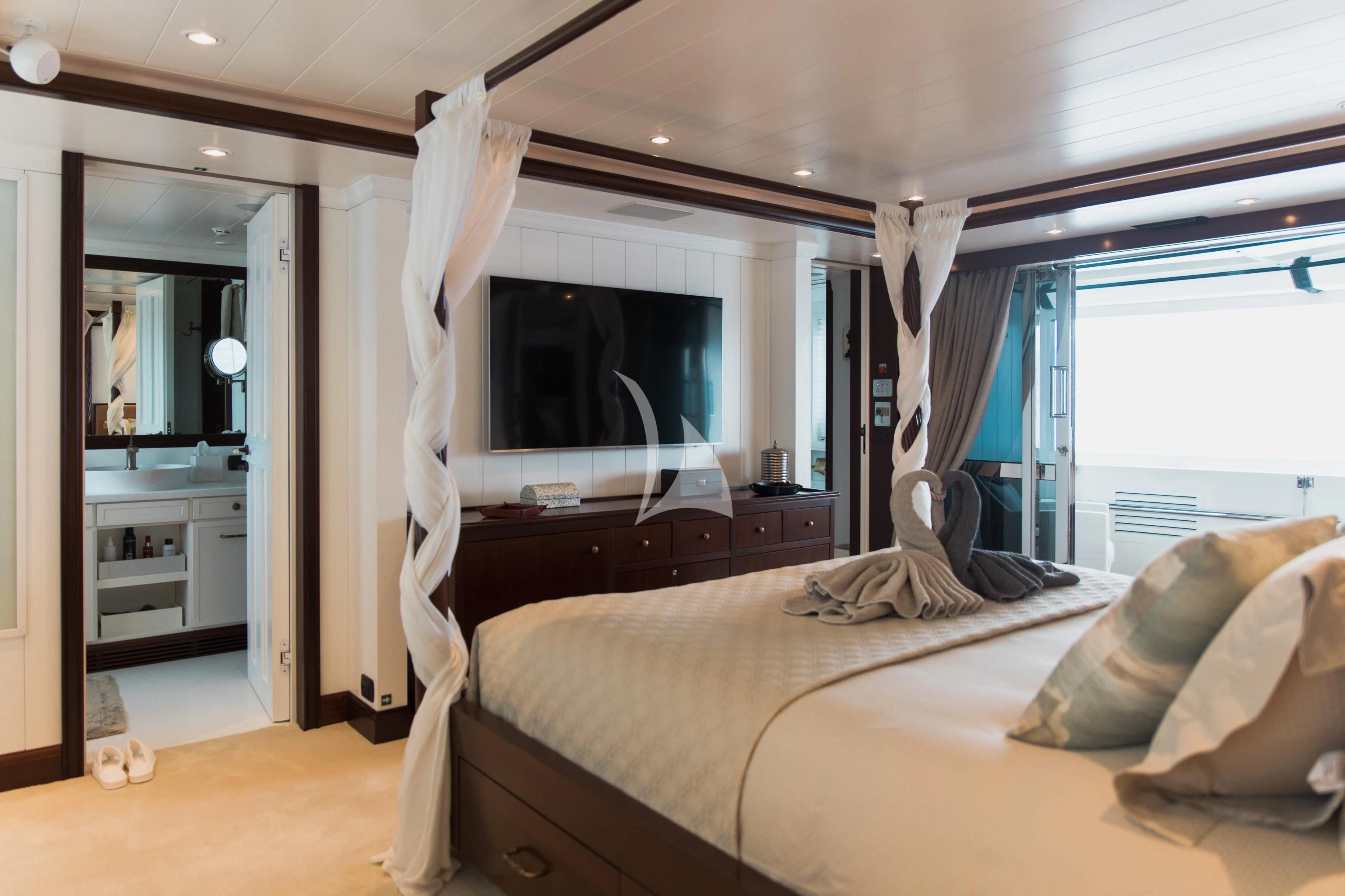 a bedroom with a bed and a television aboard LADY TRUDY Yacht for Charter