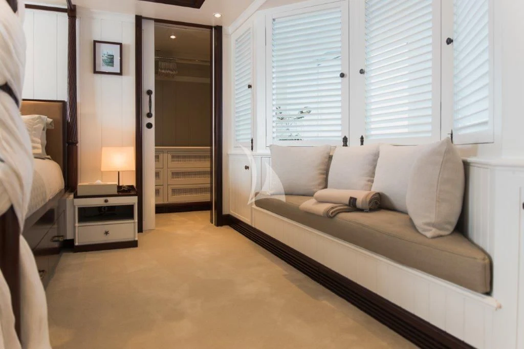 a room with a bed and a couch aboard LADY TRUDY Yacht for Charter