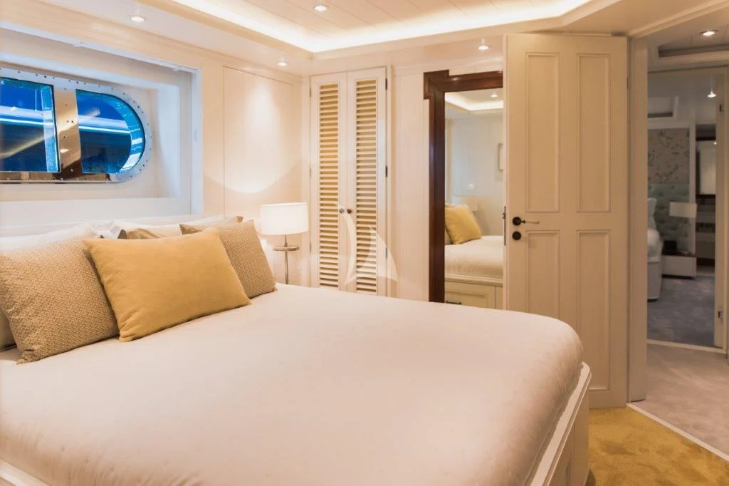 a bedroom with a bed and a door aboard LADY TRUDY Yacht for Charter