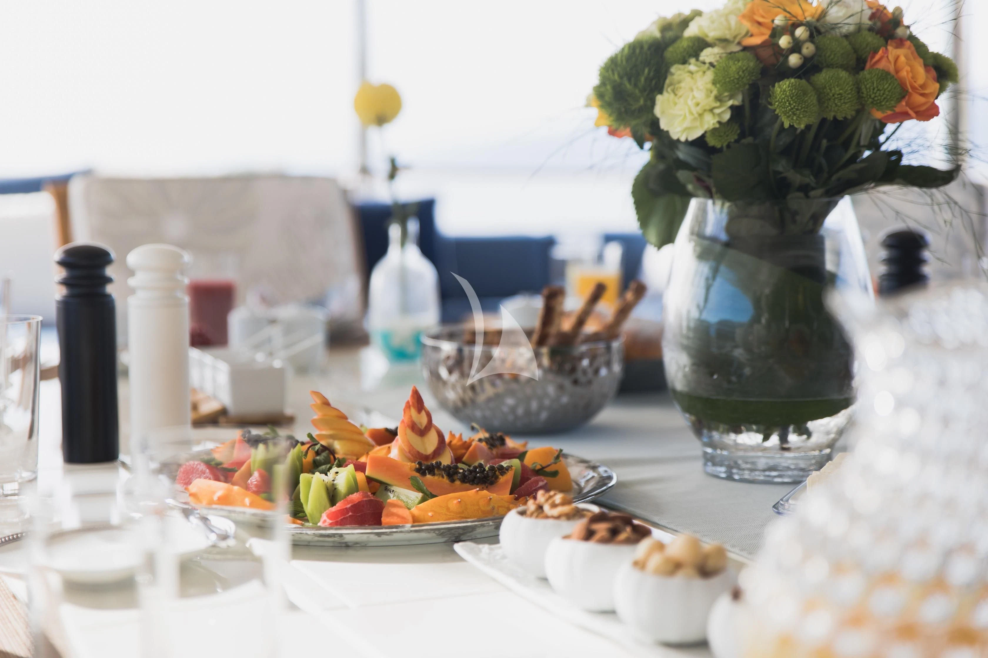 a table with food and flowers aboard LADY TRUDY Yacht for Charter