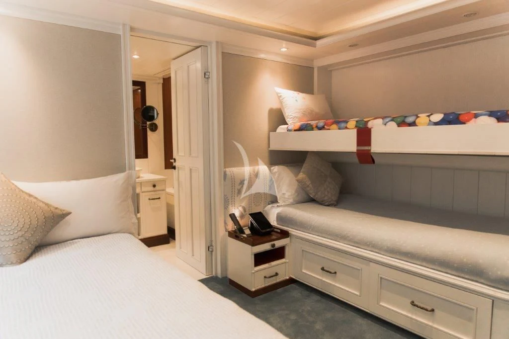 a room with a bed and a dresser aboard LADY TRUDY Yacht for Charter