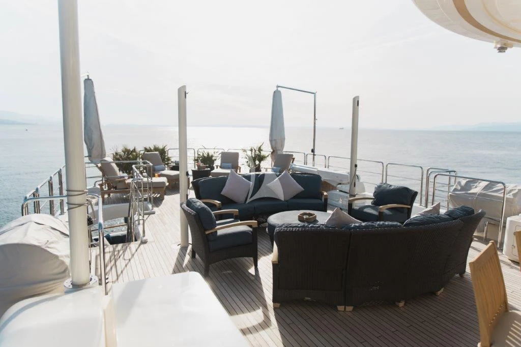 a room with a large balcony overlooking the ocean aboard LADY TRUDY Yacht for Charter