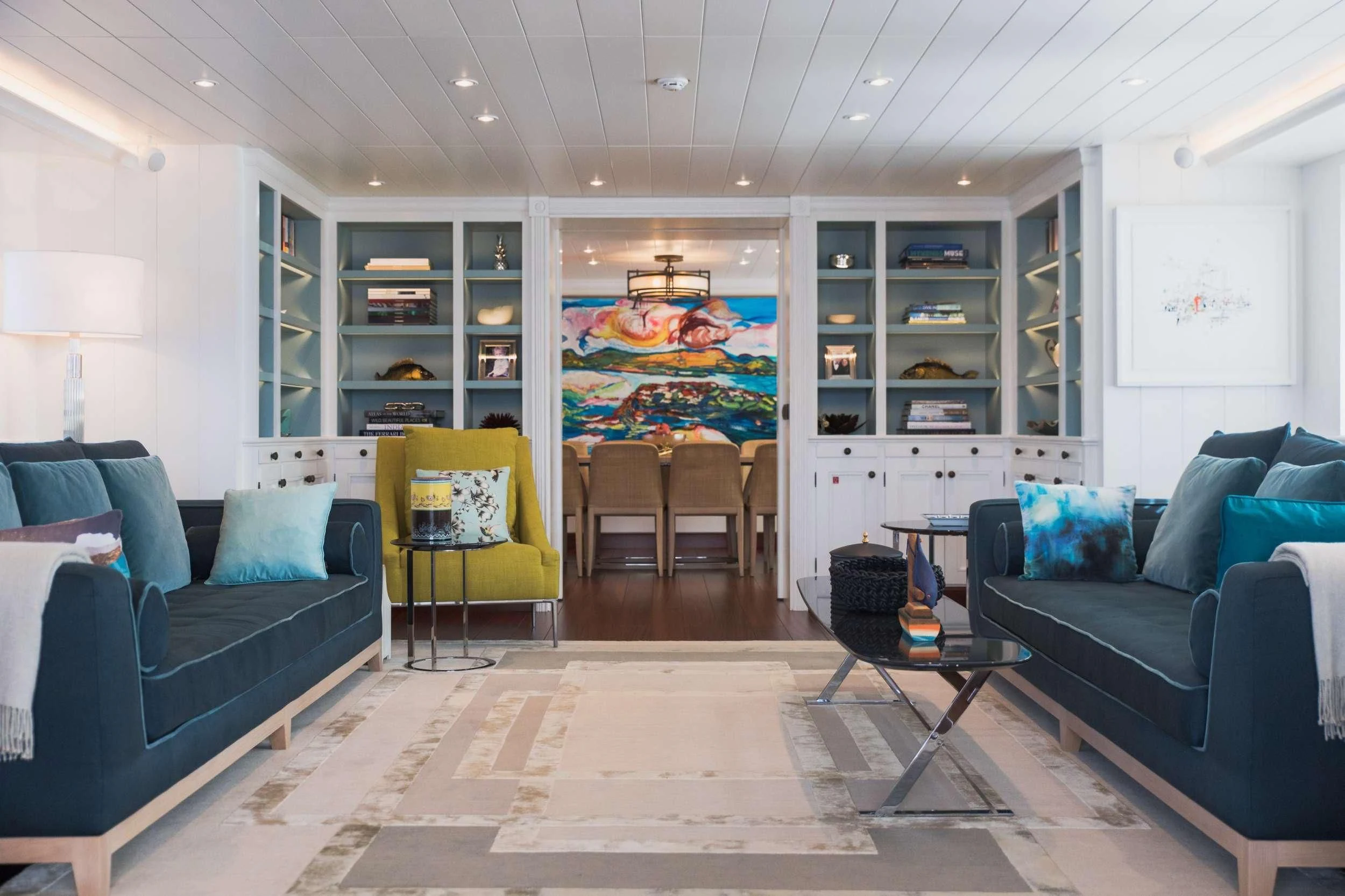 a living room with blue couches aboard LADY TRUDY Yacht for Charter