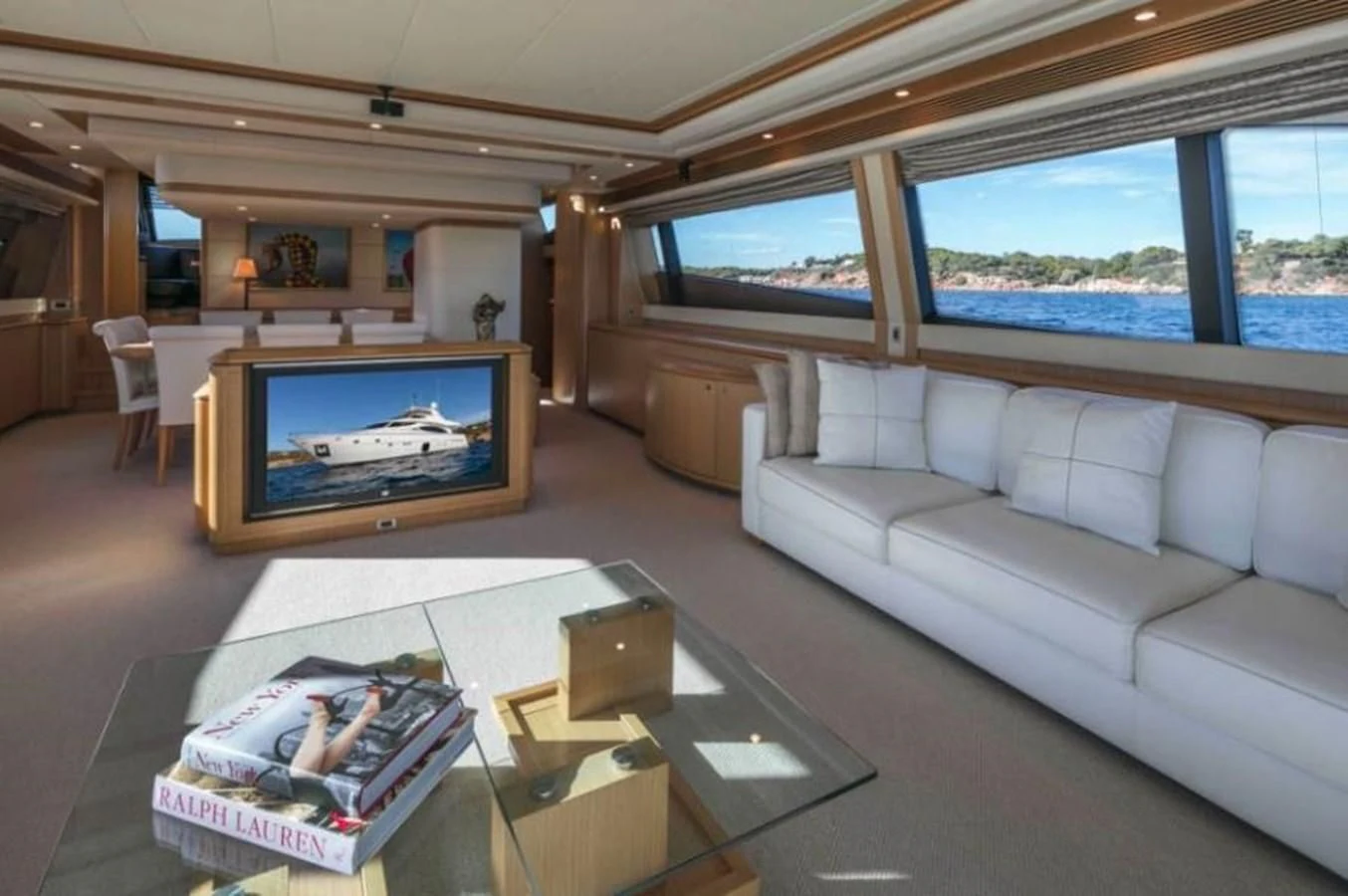 a living room with a large screen aboard FAIR LADY SILVIA Yacht for Sale