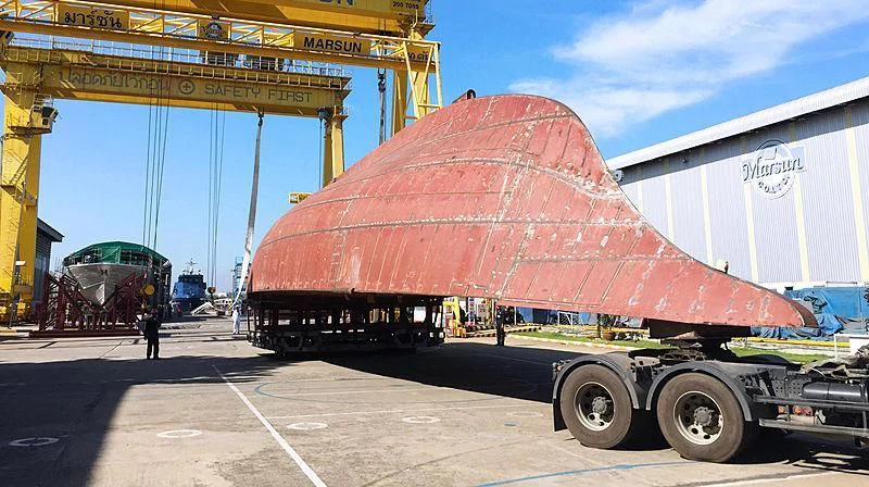 a red covered boat on a trailer aboard VELA Yacht for Sale