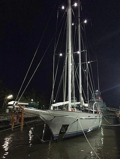 a large white boat with a large sail aboard VELA Yacht for Sale