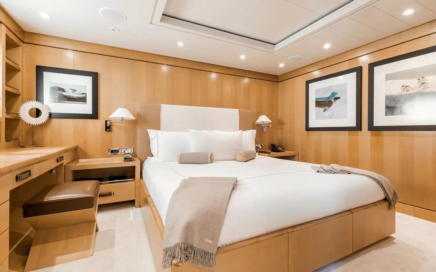 a hotel room with a bed and a desk aboard LIND Yacht for Charter