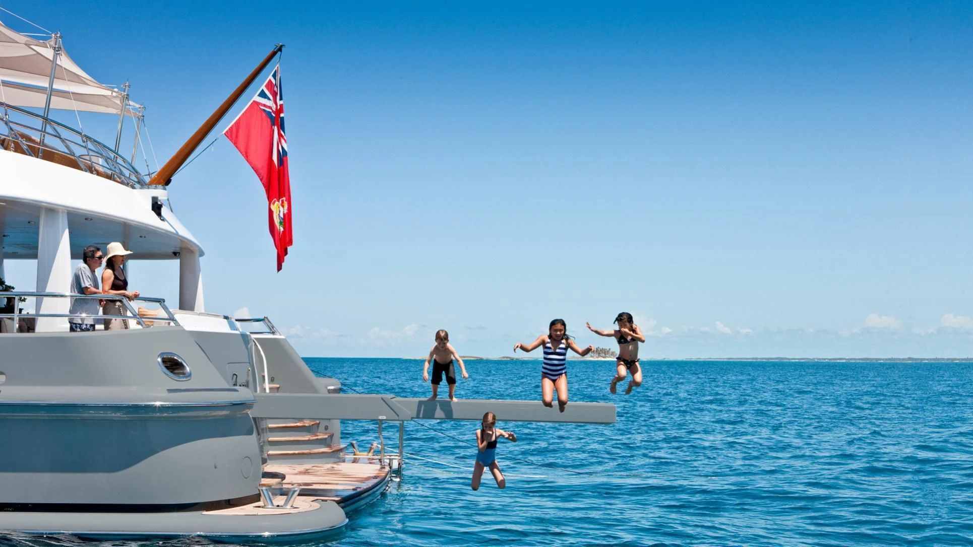 people jumping into the water aboard LIND Yacht for Charter