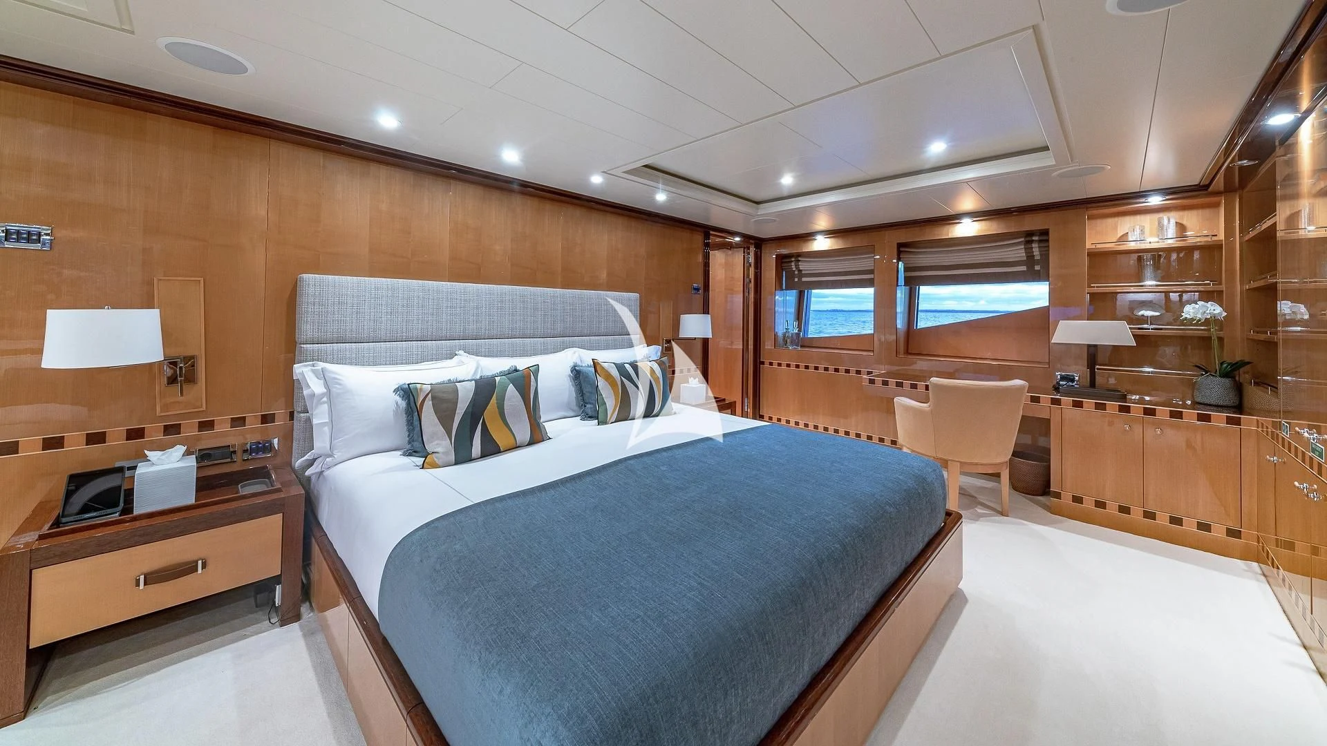 a room with a bed and a desk aboard LIND Yacht for Charter