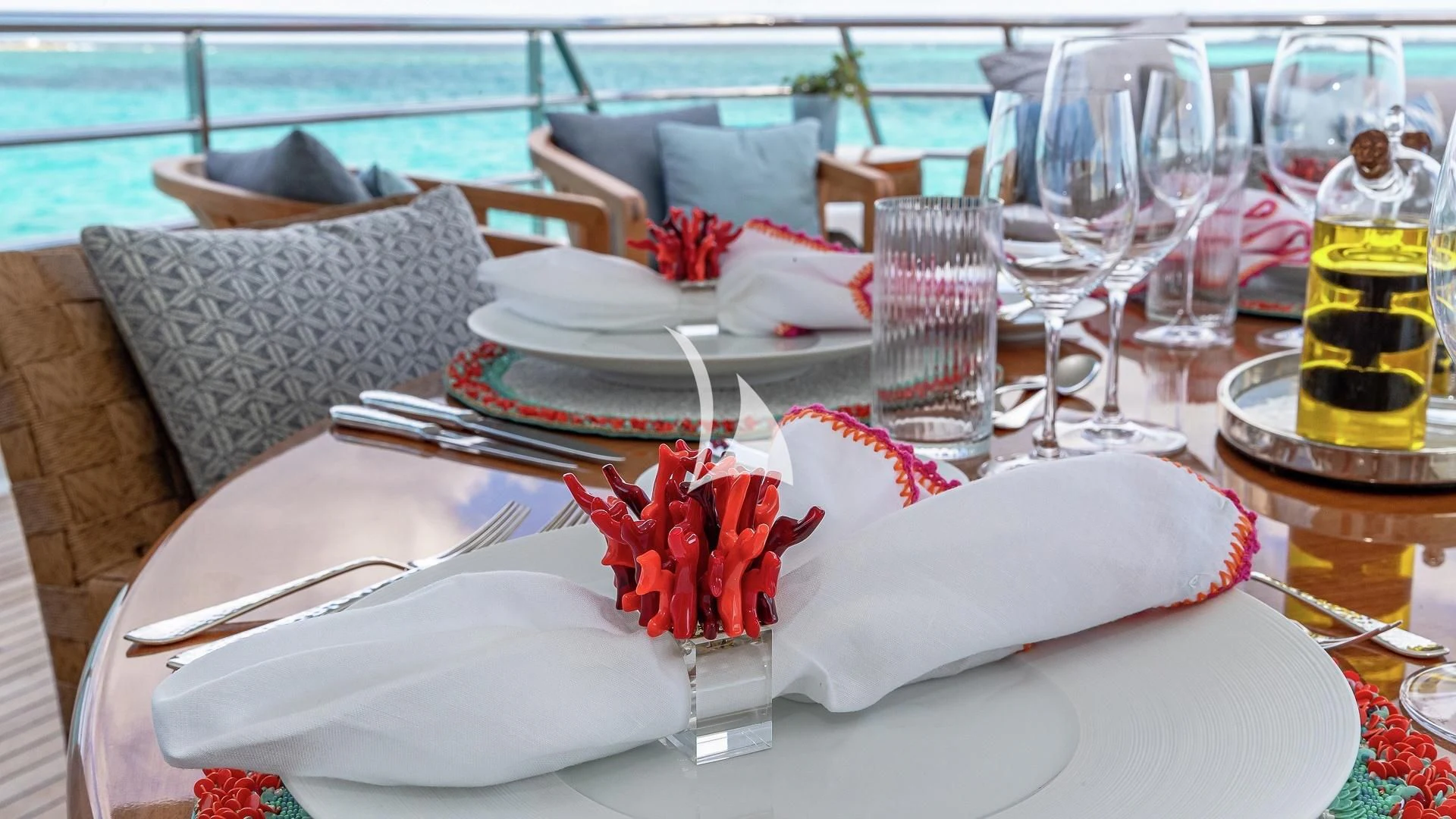 a table with plates and glasses aboard LIND Yacht for Charter