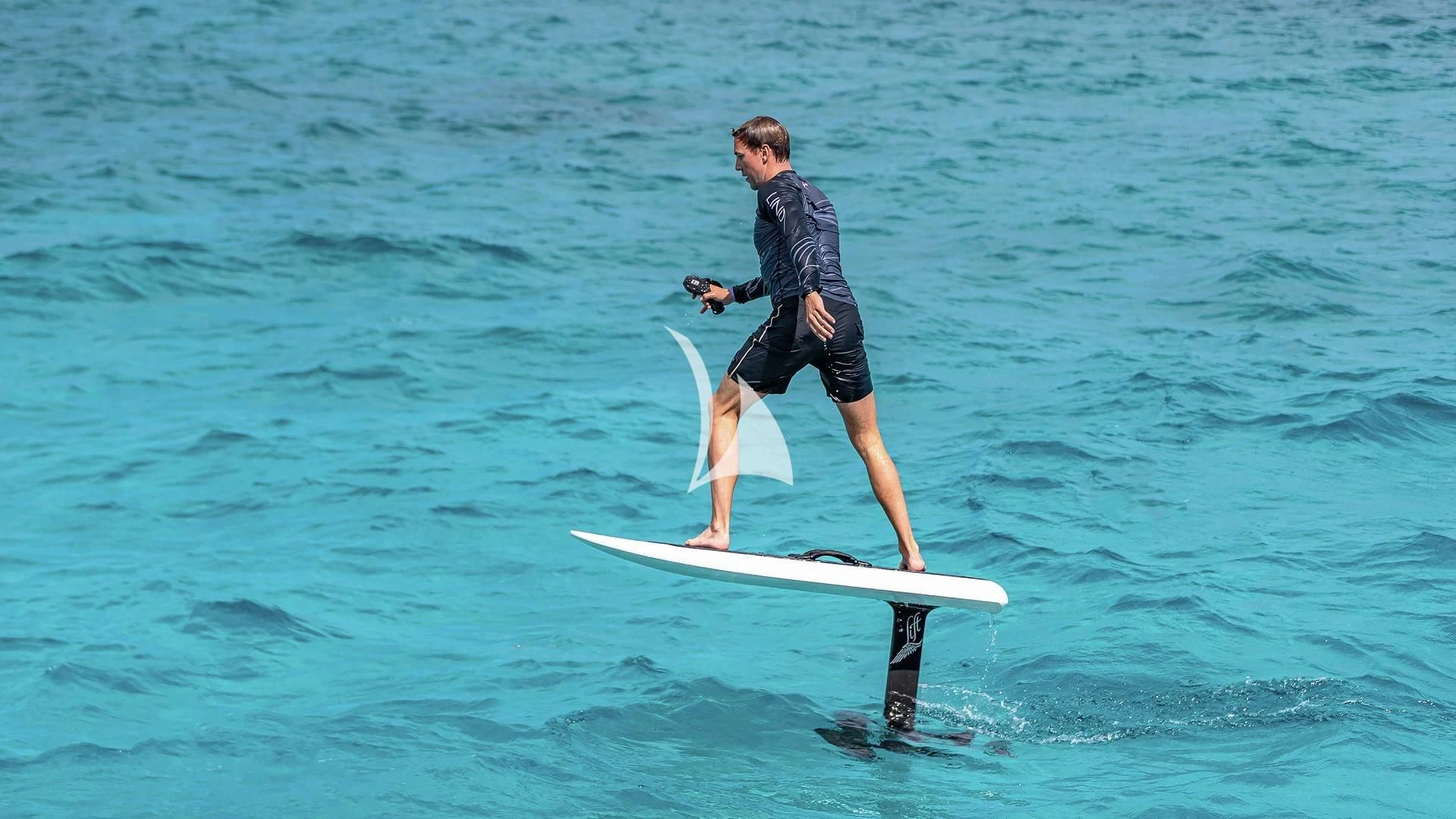 a person on a surfboard aboard LIND Yacht for Charter