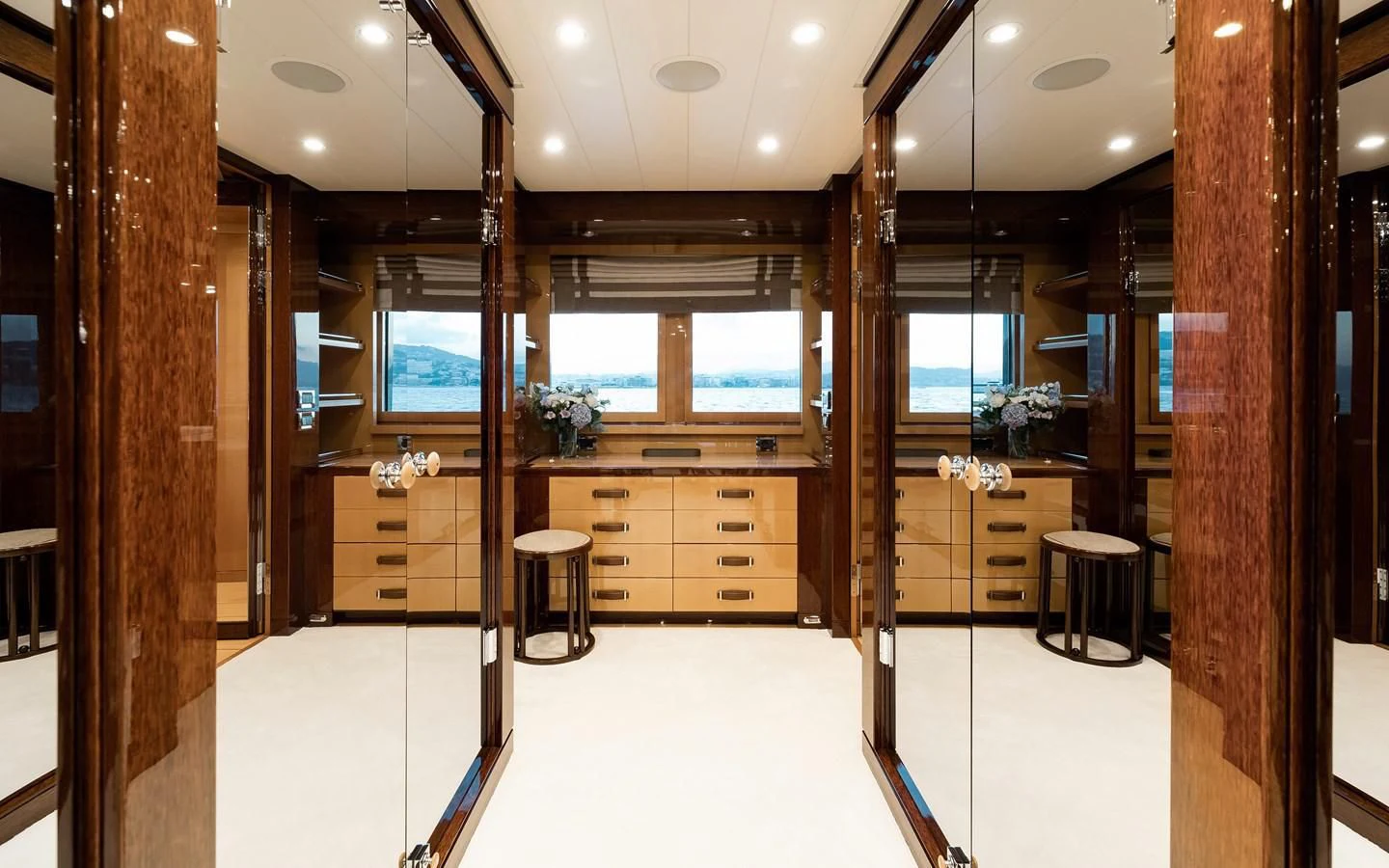 a room with a wood wall and cabinets and a stool aboard LIND Yacht for Charter