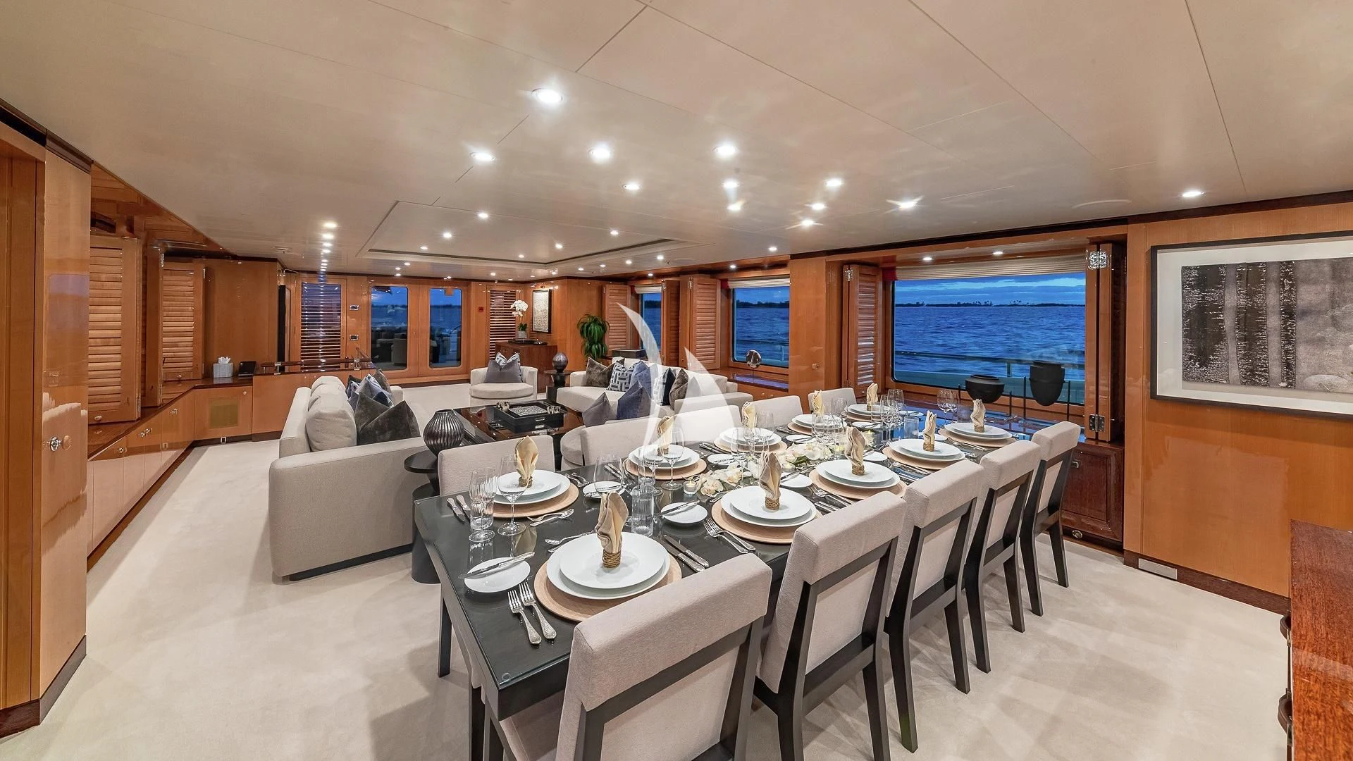 a large room with a table and chairs aboard LIND Yacht for Charter