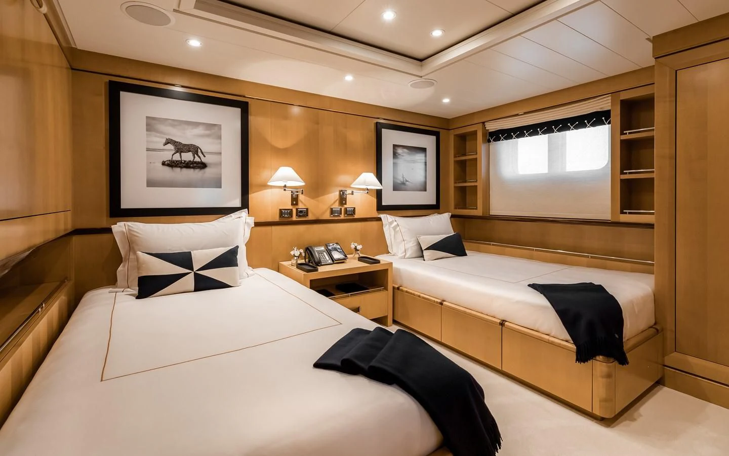 a room with a bed and a desk aboard LIND Yacht for Charter