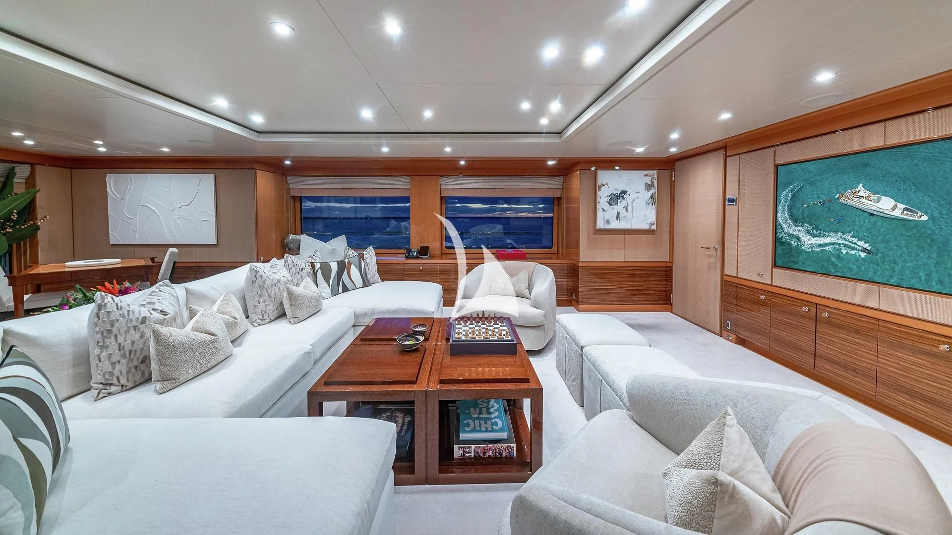 a room with a bed and a television aboard LIND Yacht for Charter