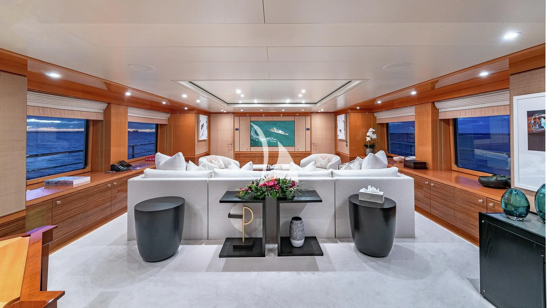 a large room with a table and chairs aboard LIND Yacht for Charter