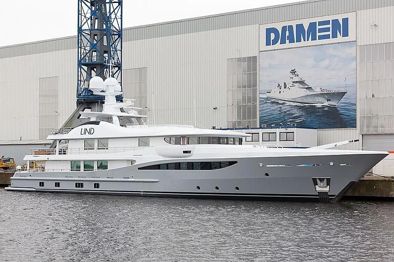 a large white boat in a harbor aboard LIND Yacht for Charter