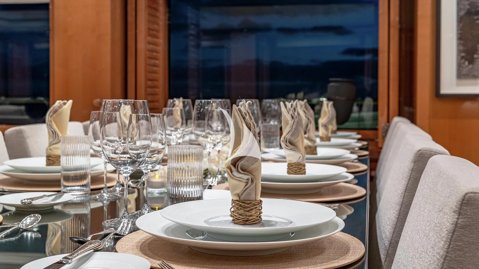 a table with a plate of desserts and glasses on it aboard LIND Yacht for Charter