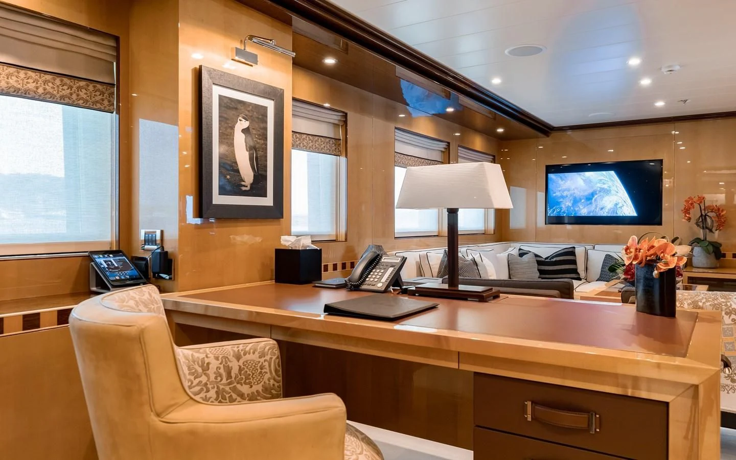a room with a desk and a tv on the wall aboard LIND Yacht for Charter