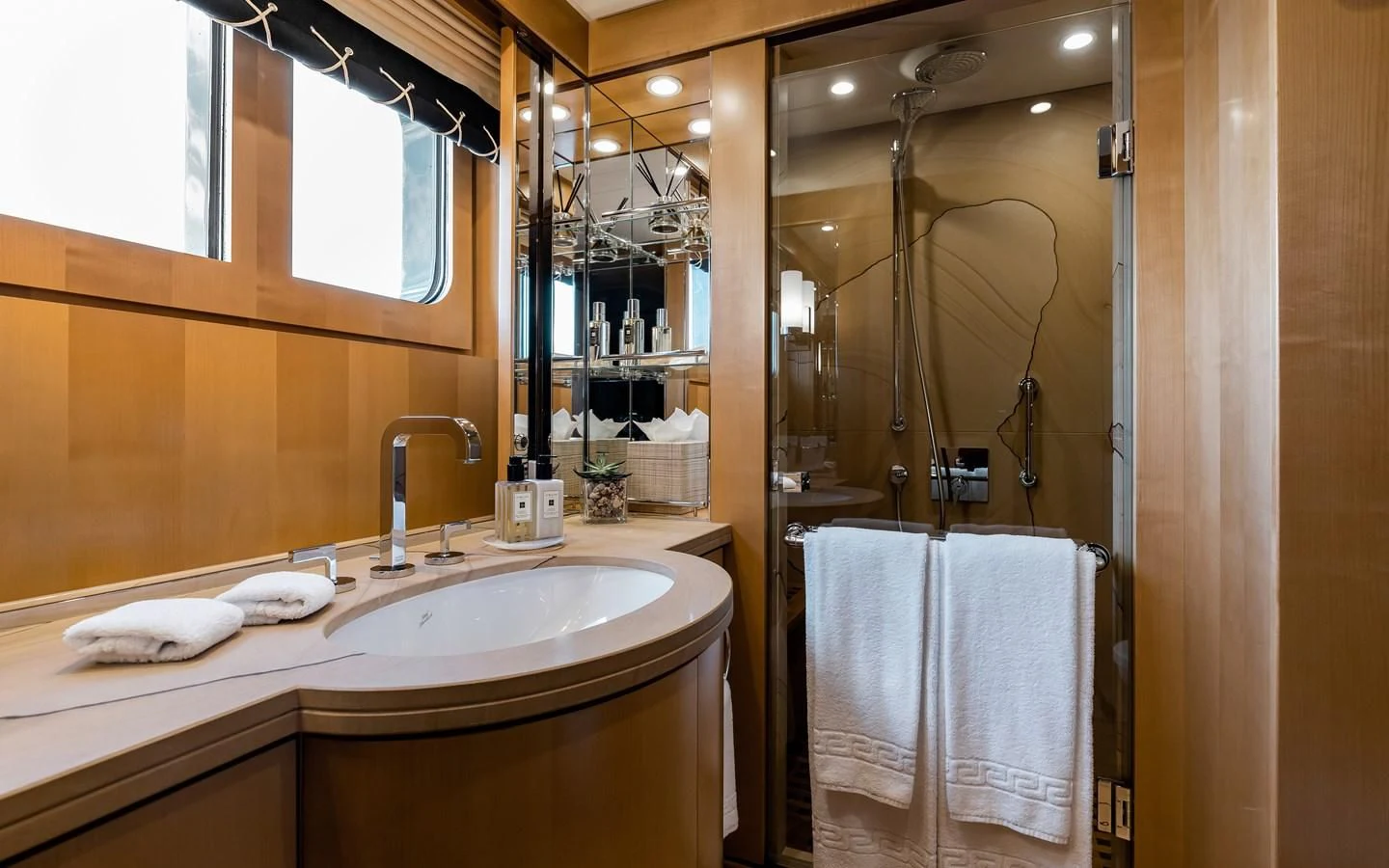 a bathroom with a glass shower aboard LIND Yacht for Charter