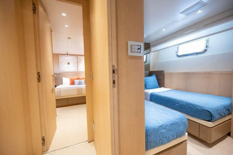 a room with a bed and a closet aboard ASTONISH Yacht for Sale